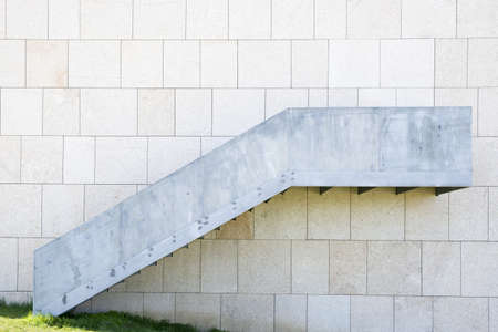 Metal Stairs with Hidden Door  Wall Stone Textured Backgroundの写真素材