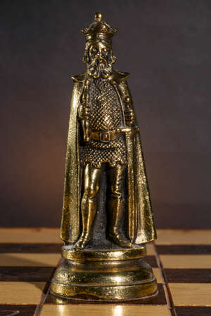 Metallic Chess Piece on Its Boardの写真素材