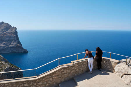 Latin family, woman and children, enjoying the views of the Mediterranean, on a sunny spring day, on holiday in Mallorca, in the viewpoint, visiting, El Cap de Formentor, Mallorca, Balearic Islands, Spainの写真素材