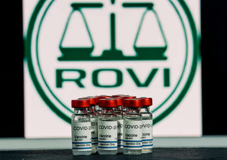 MALLORCA / SPAIN- November 17, 2020: Rovi pharmaceutical laboratory manufactures Moderna vaccine for Coronavirus (Covid 19) research. Row of vaccine bottles with the Rovi Pharmaceutical Company logo blurred in the background.のeditorial素材