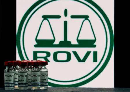 MALLORCA / SPAIN- November 17, 2020: Rovi pharmaceutical laboratory manufactures Moderna vaccine for Coronavirus (Covid 19) research. Row of vaccine bottles with the Rovi Pharmaceutical Company logo blurred in the background.のeditorial素材