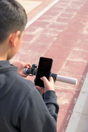 young man on an electric skate using smartphone gps applications