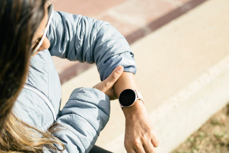 Latina Woman Checking Heart Rate on Smart Watchの写真素材