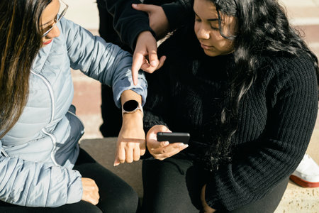 Latin People Interacting with Mobile Devices. in the parckの写真素材