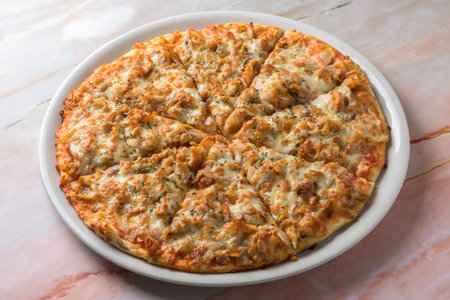 BBQ CHICKEN pizza isolated on cutting board top view on dark background italian fast foodの写真素材
