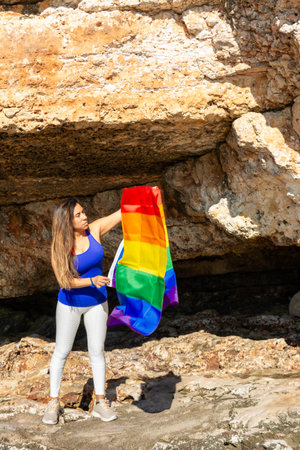 woman, middle aged, outdoors waving pride flag, concept of liberty, equalityの写真素材