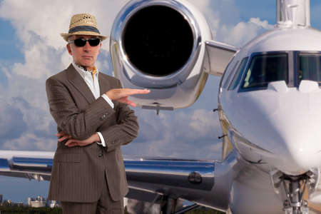 Handsome man next to private jet