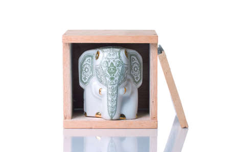 Beautiful porcelain elephant inside a wooden boxの写真素材