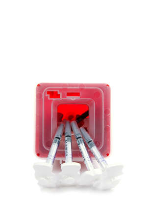 Sharps container and syringes isolated on whiteの写真素材