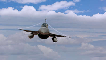 Fighter jet airborne with contrailsの写真素材