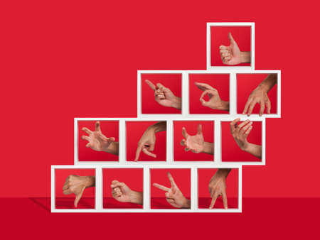 Concept of several hands gesturing inside shelvesの写真素材