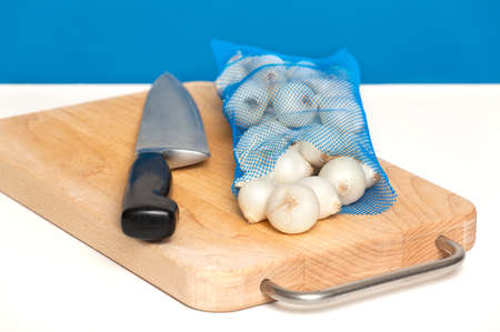 Fresh pearl onions on a white counterの写真素材