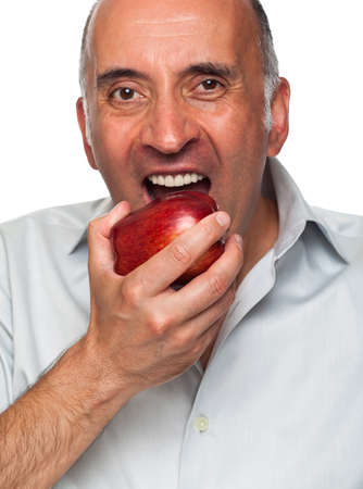 Handsome man eating an appleの写真素材