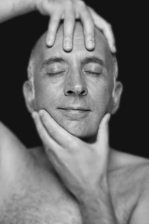 Man holding his head in an artistic wayの写真素材