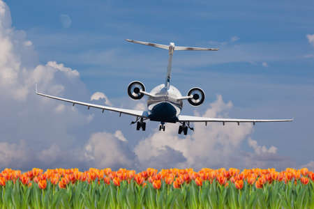 Rear view of a private jet landingの写真素材