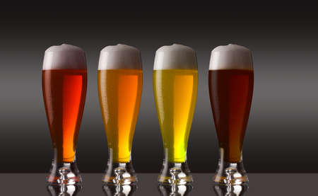 Row of various types of beer with foam