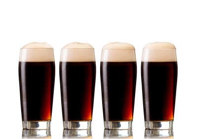 Glasses of stout beer, isolated on white