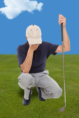 Disappointed golfer on the greenの写真素材