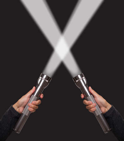 Hands holding flashlightsの写真素材