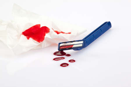 Razor with splashes of blood after a cutの写真素材