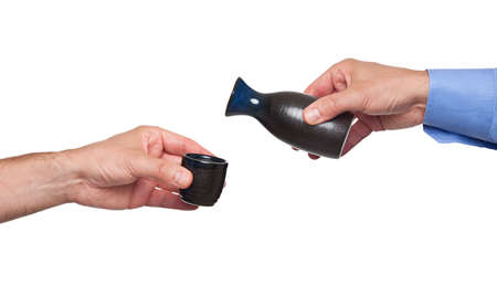 Pouring sake from its bottleの写真素材