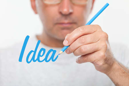 Man drawing the word idea on a glass boardの写真素材