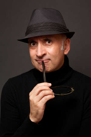 Portrait of a handsome man in a hatの写真素材