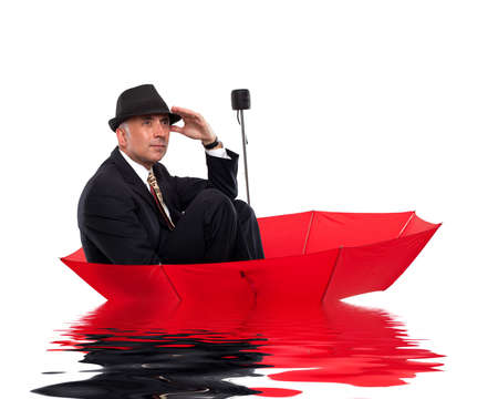 Businessman floating on umbrellaの写真素材