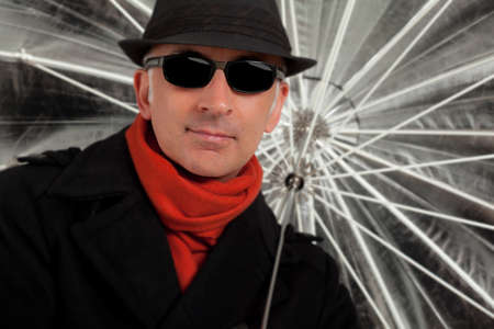 Handsome man holding an umbrella