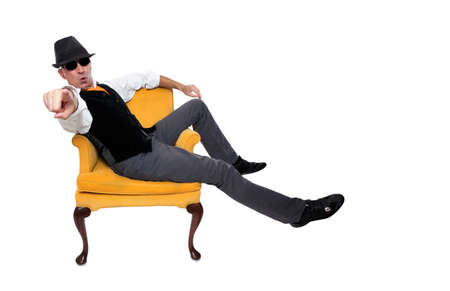 Fashionable man sitting on a chairの写真素材