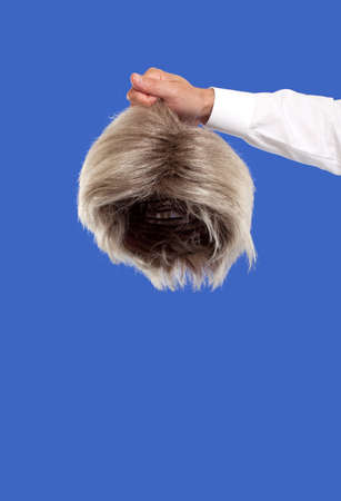 Hand holding a wigの写真素材