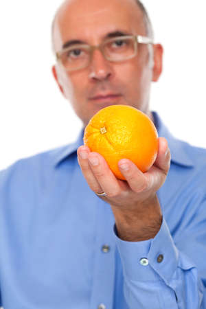 Man holding an orange up closeの写真素材