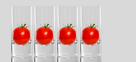 Tomatoes inside tall glassesの写真素材