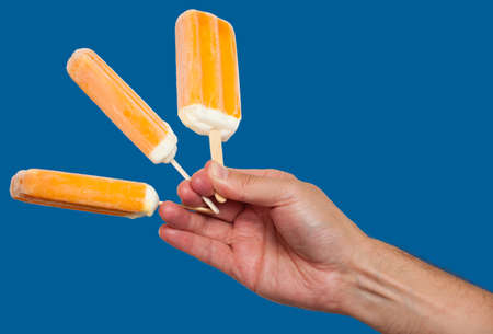 Hand holding ice cream barsの写真素材