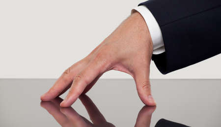 Close up of a hand on a tableの写真素材