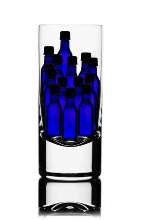 Back lit glass with little blue bottles insideの写真素材