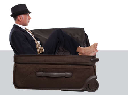 Business man inside of a suitcaseの写真素材