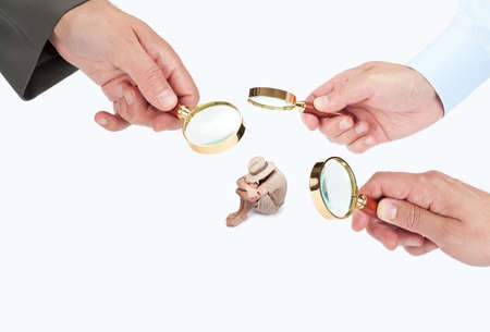Hands with magnifier glasses looking, studying or selecting a personの写真素材
