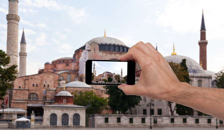 Hand taking a photo with a smart phoneの写真素材