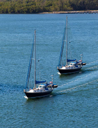 Two sail boats navigatingの写真素材