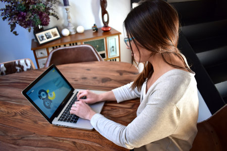 Young woman working at home with laptop