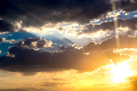 Golden sunset with clouds and blue skyの写真素材