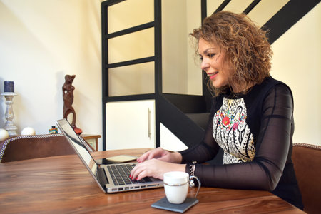 Young woman working at home with laptopの写真素材