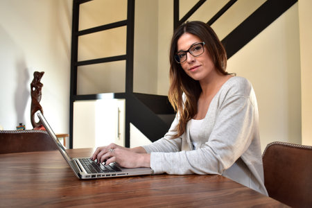 Young woman working at home with laptopの写真素材