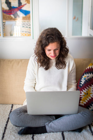 Young woman working from home with laptopの写真素材