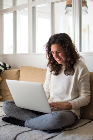 Young woman working from home with laptopの写真素材
