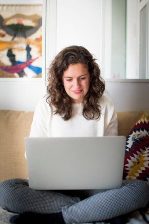 Young woman working from home with laptopの写真素材