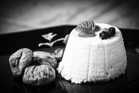 Ricotta cheese with berries, dried figs and fresh mintの写真素材