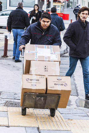 Man is pushing a cart with cardboard boxesのeditorial素材