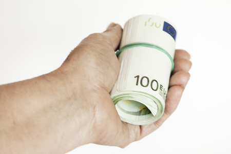Roller of banknotes in the handの写真素材